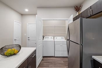 A kitchen with a refrigerator, dishwasher, and oven at Aventura at Wentzville I & II Apartments, Wentzville